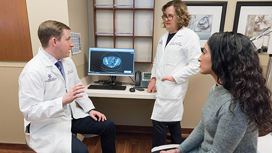 Drs in exam room consult with patient